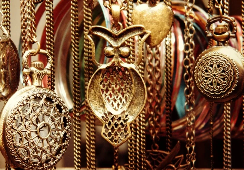 A close up of many different necklaces hanging
